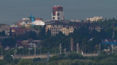 SOCHI, RUSSIA - JULY 30, 2022: Passenger plane Boeing 737 of Pobeda Airlines approaching before landing at Sochi airport, long shot. Tourism and travel concept