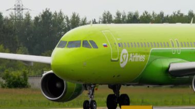 NOVOSIBIRSK, RUSSIAN FEDERATION - JULY 15, 2022: Close-up, passenger plane of S7 Airlines taxiing at Tolmachevo airport. Side view, aircraft on the taxiway. Tourism and travel concept