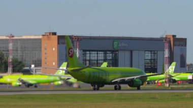 NOVOSIBIRSK, RUSSIAN FEDERATION - JUNE 12, 2022: Boeing 737-8LP, RA-73671 of S7 Airlines picks up speed and takeoff. Rear view, jet plane departure. Tourism and travel concept