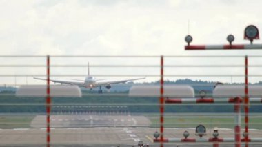 Jet airplane landing at airport. Aircraft landing gear touches runway.