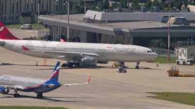 SOCHI, RUSSIA - JULY 29, 2022: Aeroflot plane departure, rear view. Airbus A330 of Nordwind Airlines on the taxiway at Sochi airport. Tourism and air travel concept