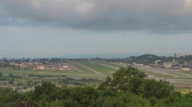 Timelapse panoramic view of the airport in daytime traffic. Clouds float beautifully over the city. Panoramic view of the runway