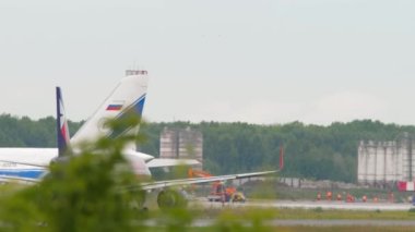 NOVOSIBIRSK, RUSSIAN FEDERATION - JULY 15, 2022: Airbus A320 of Smartavia accelerates to take off at Tolmachevo Airport. Airplane departure, side view. Tourism and travel concept