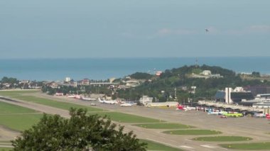 SOCHI, RUSSIA - JULY 29, 2022: Timelapse of the airport, airfield, summer sunny day. Panoramic view of the airfield and the sea in the background. Tourism and travel concept