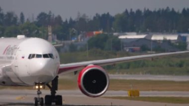 MOSCOW, RUSSIAN FEDERATION - JULY 29, 2021: Civil jet plane of Royal Flight taxiing at Sheremetyevo airport, front view. Haze on the airfield. Tourism and travel concept
