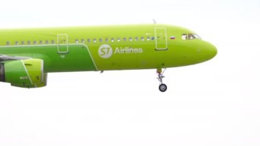 NOVOSIBIRSK, RUSSIAN FEDERATION - JULY 15, 2022: Airbus A321-211, RA-73416 of S7 Airlines approaching for landing, slow motion. Footage of a passenger jet plane flies, side view.