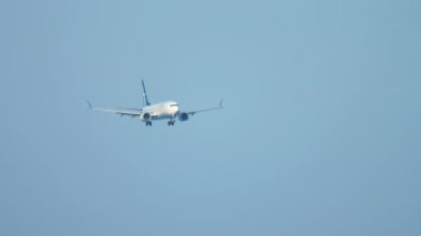 PHUKET, THAILAND - NOVEMBER 26, 2016: Boeing 737 of SilkAir landing at Phuket Airport, front view. Tourism and travel concept