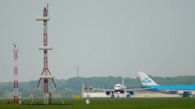 AMSTERDAM, THE NETHERLANDS - JULY 27, 2017: Civil aircraft British Airways speed up and take off, long shot. Passenger plane fly away. Tourism and travel concept