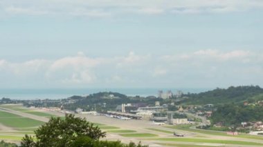 Rapid movement of airplanes and buses with passengers at the airport along the take-off field in the rays sun. Time-lapse. Tourism and travel concept