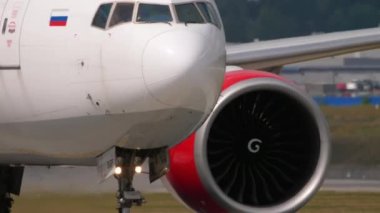 MOSCOW, RUSSIAN FEDERATION - JULY 29, 2021: Jet plane of Royal Flight taxiing at Sheremetyevo airport, front view. Aircraft engine and nose, taxiing. Concept aviation and tourism