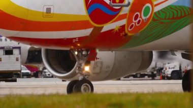 PHUKET, THAILAND - DECEMBER 05, 2016: Airbus A320-232, HS-PGU of Bangkok Airways Guilin Livery taxiing, view through Phuket airport fence. Tourism and travel concept