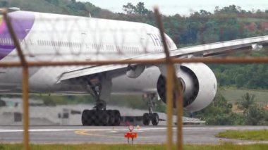 PHUKET, THAILAND - DECEMBER 05, 2016: Widebody passenger aircraft Thai Airways accelerating for takeoff at Phuket airport. Tourism and travel concept