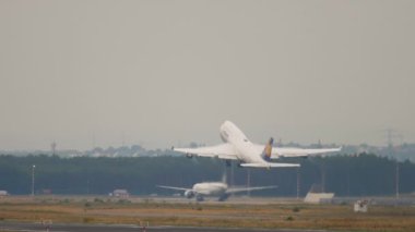 FRANKFURT AM MAIN, GERMANY - JULY 20, 2017: Boeing 747 Lufthansa taking off in a downpour at Frankfurt Airport. Widebody plane departure. Huge four-engine plane flying away