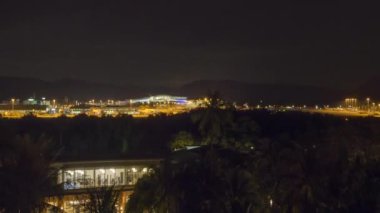 Timelapse, footage of the airport at night outside. Traffic at night. Aircraft taxiing to the terminal after landing. Airfield lighting with landing lights