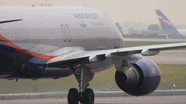 MOSCOW, RUSSIAN FEDERATION - JULY 28, 2021: Jet passenger aircraft Aeroflot rides on the taxiway, side view. Tourism and travel concept.