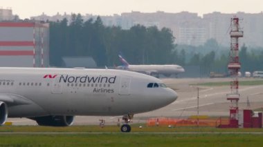 MOSCOW, RUSSIAN FEDERATION - JULY 30, 2021: Plane of Nordwind Airlines taxiing at Sheremetyevo Airport Moscow, side view. Tourism and travel concept