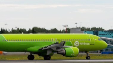 NOVOSIBIRSK, RUSSIAN FEDERATION - JULY 15, 2022: Commercial plane of S7 Airlines takeoff, side view. Airplane departure. Tourism and travel concept
