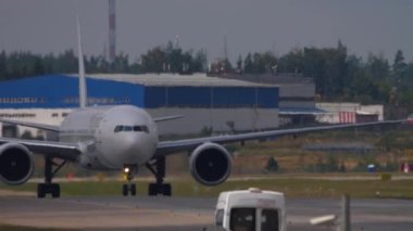 Footage of aircraft taxiing, front view. Passenger airliner on the taxiway at the airport on a summer day. Taxiing Passenger Jet