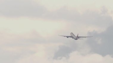 Footage of passenger plane takeoff and climbing, long shot rear view. Tourism and travel concept