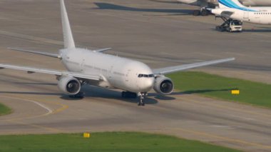 SOCHI, RUSSIA - AUGUST 04, 2022: Boeing 777 of Nordwind Airlines taxiing on airfield of Sochi airport. Widebody airliner on taxiway.