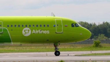 NOVOSIBIRSK, RUSSIAN FEDERATION - JULY 15, 2022: Passenger plane taxiing on the runway at airport. Aircraft on the taxiway. Tourism and travel concept