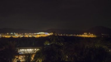 Airfield, panoramic view. Airport illuminated by lights. Airport view at night, timelapse