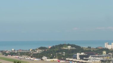 SOCHI, RUSSIA - JULY 29, 2022: Time-lapse footage of the airfield at Sochi airport, sea background