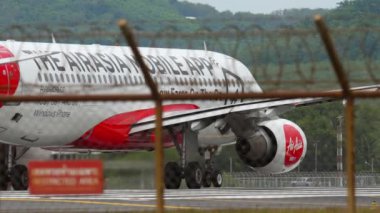 PHUKET, THAILAND - NOVEMBER 26, 2017: AirAsia Airbus A320 with Mobile App Livery Book, Manage, Check in takes off at Phuket Airport. Tourism and travel concept