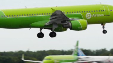 NOVOSIBIRSK, RUSSIAN FEDERATION - JULY 15, 2022: Plane Airbus A320-214, RA-73420 of S7 Airlines approaching before landing, side view. Airplane flies. Tourism and travel concept