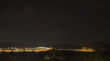 Timelapse of airport at night outside. Traffic at night. Aircraft taxiing to the terminal after landing. Airfield lighting with landing lights