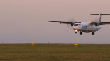 KAZAN, RUSSIA - AUGUST 05, 2022: Aircraft ATR-72 of UTair arriving. Turboprop plane landing. Airplane descent, sunset or dawn