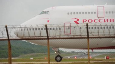 PHUKET, THAILAND - NOVEMBER 26, 2017: Passenger jet airplane Boeing 747 of Rossiya taxiing on runway at Phuket airport, close up. Tourism and travel concept