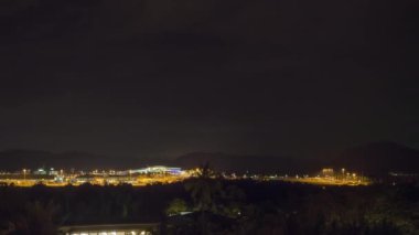 Airport traffic night. Airport illuminated by lights. Traffic at night, timelapse. Tourism and travel concept