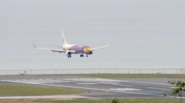 PHUKET, THAILAND - NOVEMBER 27, 2017: Footage of plane Boeing 737 NOK Air approaching to landing at Phuket airport. Tourism and travel concept. Airplane flies