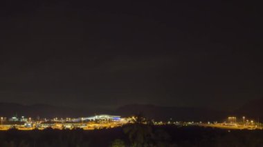 Cinematic footage of the airport airfield at night. Timelapse of aviation traffic. Airport illumination at night