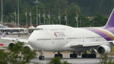 PHUKET, THAILAND - DECEMBER 02, 2016: Passenger huge airplane Boeing 747 of Thai Airways taxiing on runway before take off at Phuket airport. Jumbo jet departure