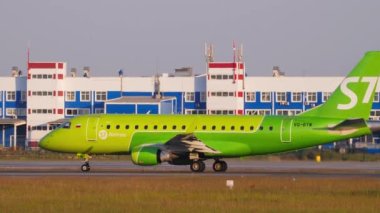 NOVOSIBIRSK, RUSSIAN FEDERATION - JUNE 17, 2020: Embraer E170SU, VQ-BYW of S7 Airlines at the start of the runway at Tolmachevo Airport, Novosibirsk, side view. Tourism and travel concept