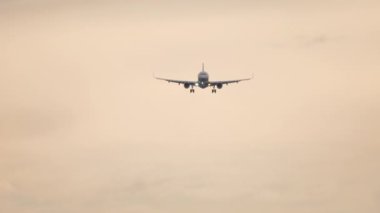 Long shot of an unrecognizable jet plane descending to land. Airliner flies. Tourism and travel concept