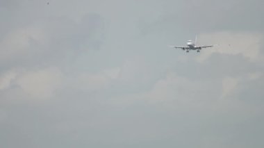 Footage of jet plane landing. Long shot of an unrecognizable aircraft approaching, descending. Tourism and travel concept