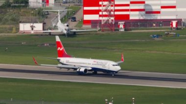 SOCHI, RUSSIA - JULY 31, 2022: Boeing 737 of Nordwind Airlines braking after landing, arriving at Sochi airport. Passenger flight, runway. Tourism and travel concept