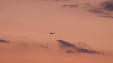 Commercial jet airplane departure, fly away at sunset. Airplane in flight. Tourism and travel concept