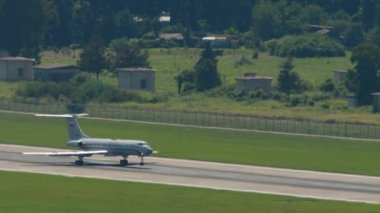 SOCHI, RUSSIA - JULY 28, 2022: Airplane Tupolev Tu-134 of Rossiya - Special Flight Squadron braking after landing at Sochi airport, side view long shot. Tourism and travel concept