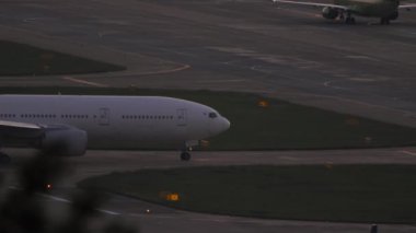 SOCHI, RUSSIA - AUGUST 04, 2022: Side view of Boeing 777 of Nordwind Airlines taxiing on airfield of Sochi airport. Widebody airliner rides on taxiway.