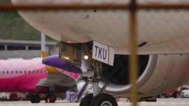 PHUKET, THAILAND - DECEMBER 05, 2016: Close shot of engine and chassis. Wheels rubber tire rear landing gear racks airplane aircraft, under wing view