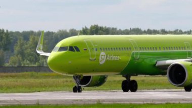 NOVOSIBIRSK, RUSSIAN FEDERATION - JULY 15, 2022: Airplane S7 Airlines taxiing on the runway at Tolmachevo airport. Plane on the taxiway. Tourism and travel concept