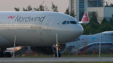 KAZAN, RUSSIA - AUGUST 05, 2022: Jet plane of Nordwind Airlines taxiing. Passenger airplane on the taxiway at the airport. Tourism and travel concept