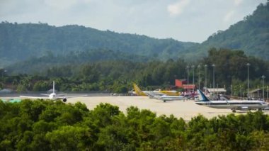PHUKET, THAILAND - DECEMBER 05, 2016: Timelapse. Passenger airplane at Phuket Airport. Takeoff landing taxiing, panoramic view. Tourism and travel concept