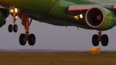 Airplane landing on the runway at the airport with smoke from the chassis, touchdown with tire smoke. Vacation, travel and aviation concept