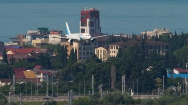 SOCHI, RUSSIA - JULY 28, 2022: Passenger jet plane of Yamal Airlines landing at Sochi airport. Passenger flight, arrival. Tourism and travel concept