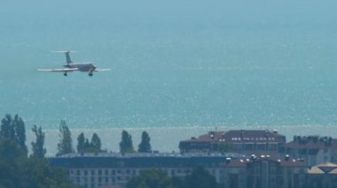 SOCHI, RUSSIA - JULY 28, 2022: Airplane Tupolev Tu-134 of Rossiya landing at Sochi airport, side view long shot. Sea in the background. Tourism and travel concept